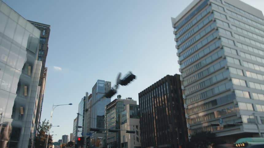 Driving through downtown past a busy intersection surrounding by buildings