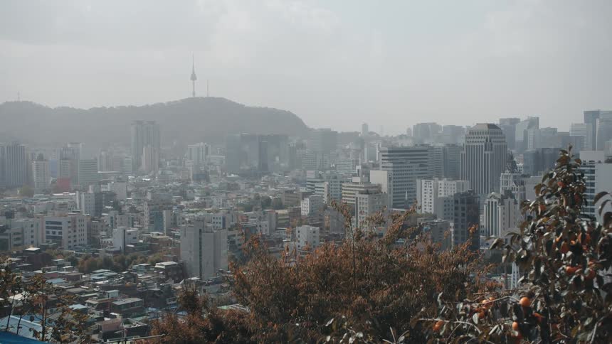 Clouds hang over a large metro city