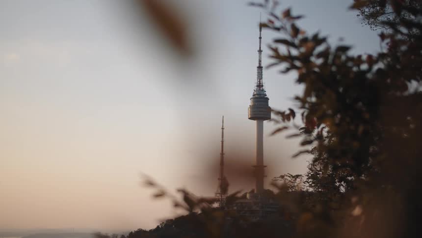 An electrical tower sits on top of a hill