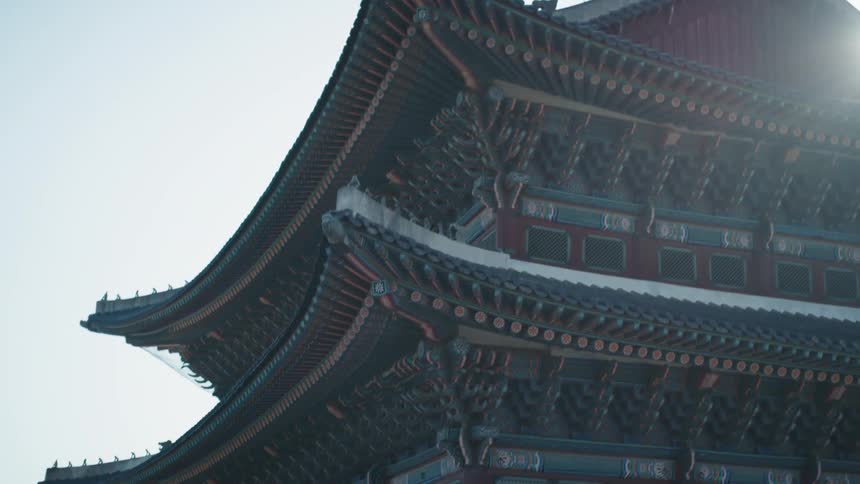Sunlight shines over a building with asian architecture