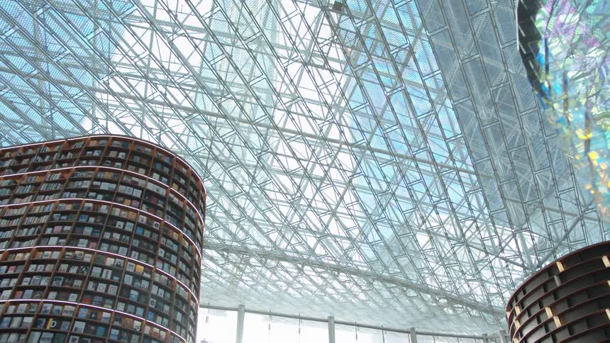 Light coming through the large glass ceiling reflects and creates color on the structures inside