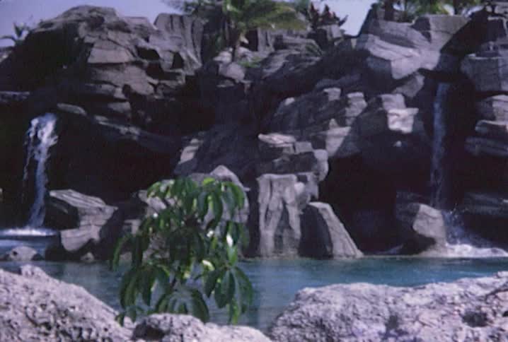 Water falling from rocks into a river