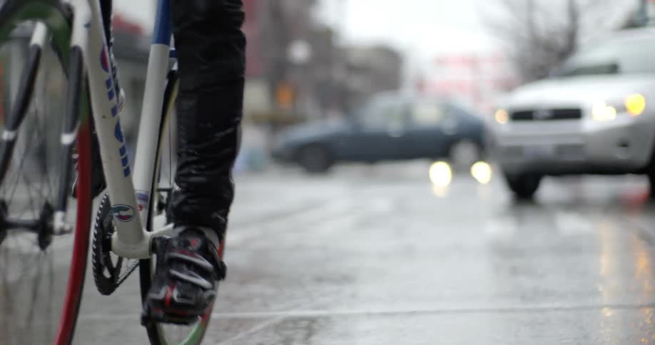 A person rides their bike on a city street