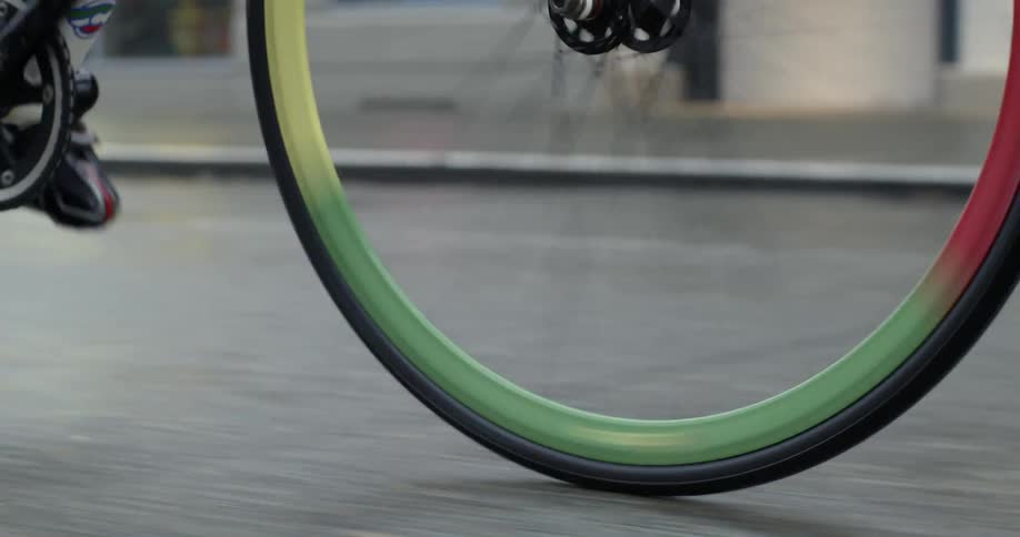 Multi colored bicycle tires while being peddled