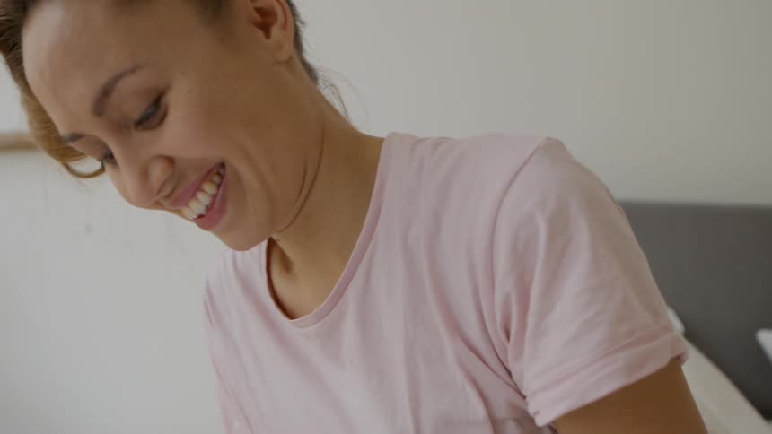 A woman is looking down smiling