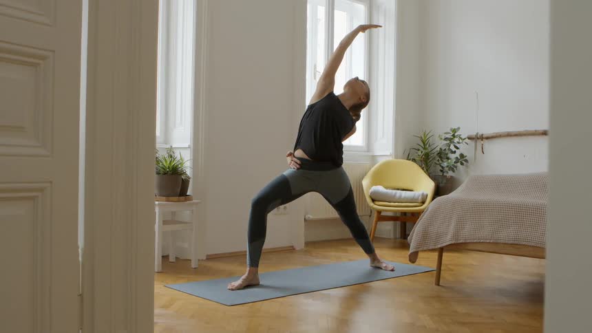 Woman in black clothes performs ballet positions