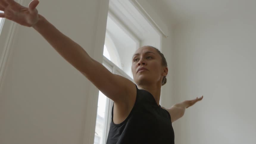 A young woman does yoga