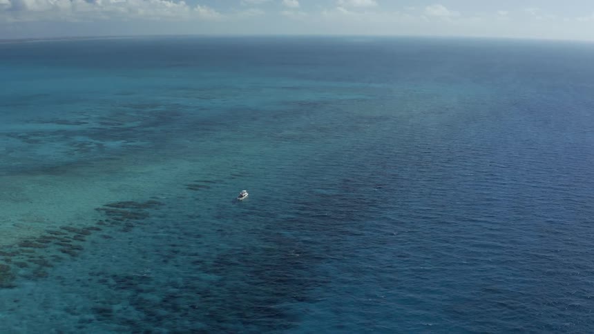 Ariel view of a boat coasting out in the middle of the sea