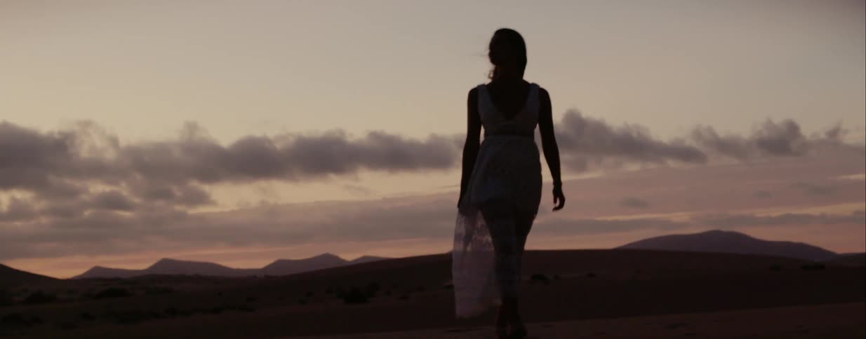 A model poses while walking in the desert