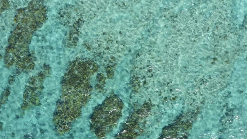 An aerial view of water rippling in an ocean