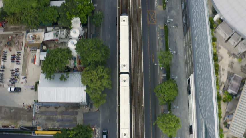 A train travels across the tracks of a large city