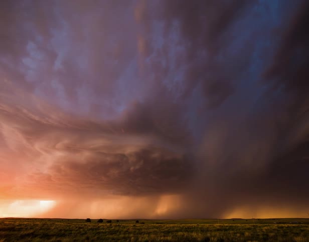 Lighting flashes as a storm rolls over an empty field
