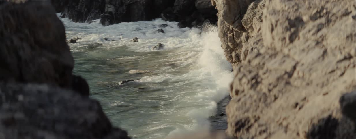 Waves crash against cliffs