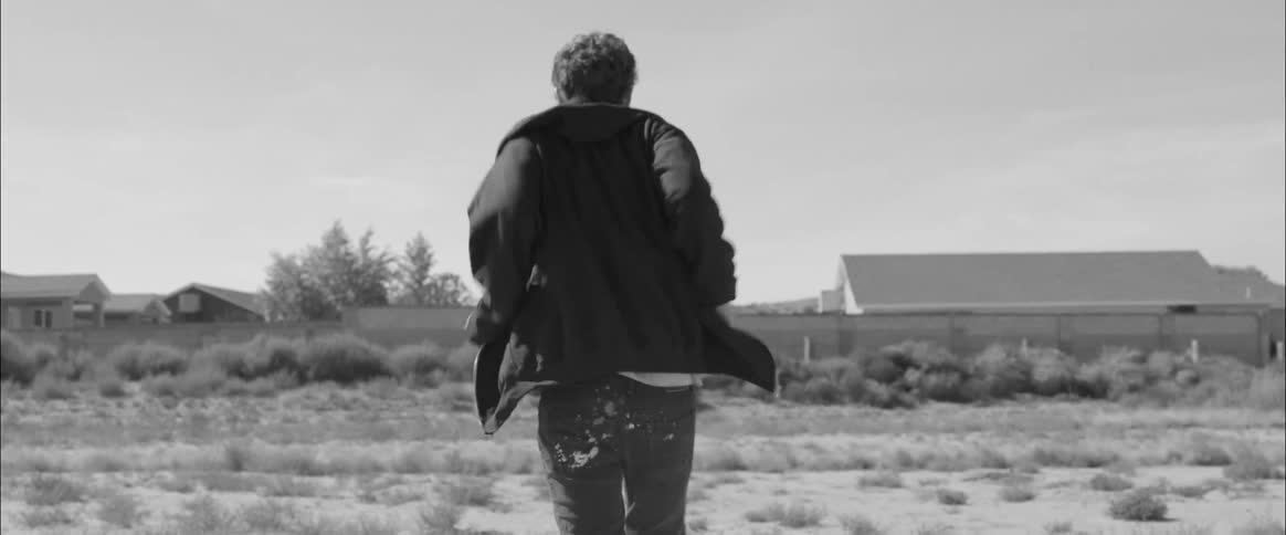 A man quickly walks across a field