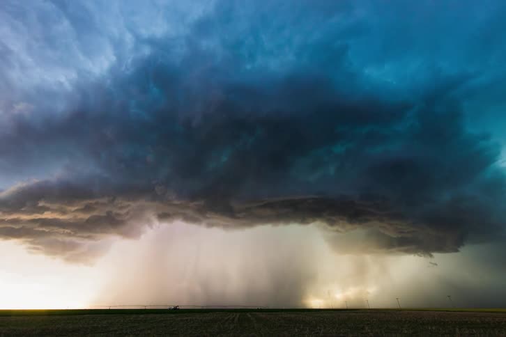 Clouds and rain pass over a field