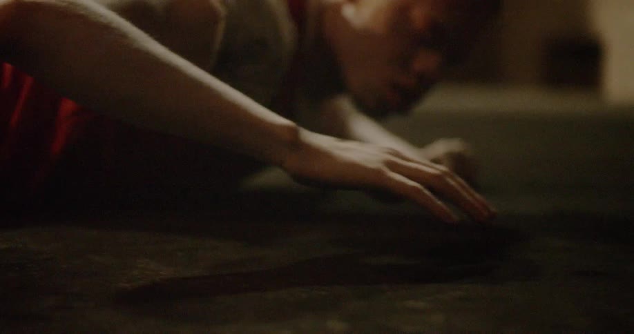 Young albino black man laying on stomach on ground