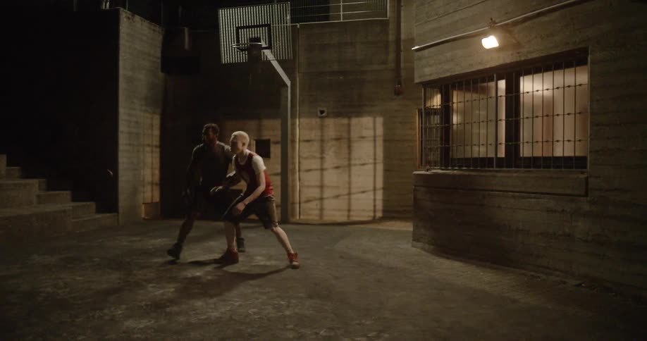 Four teens play basketball together