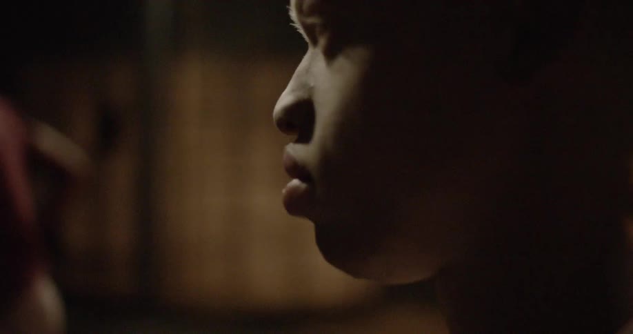 A young black man looks around