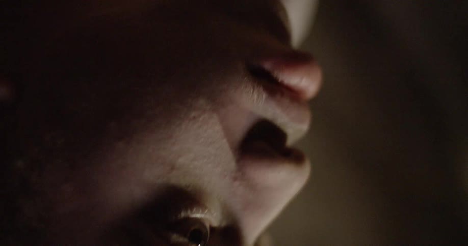 Camera pans in close up of african american man in basketball jersey