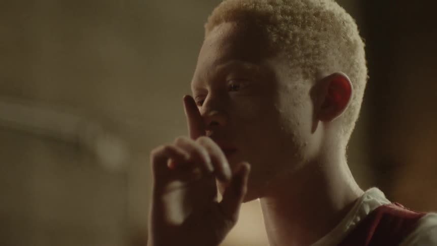 African american teenager puts finger up to nose