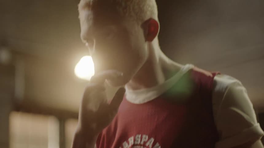 A man puts his finger to his lip