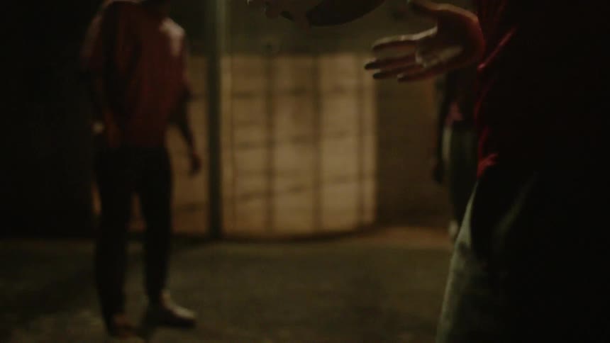 A group of teens play basketball together