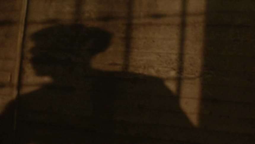 Shadow of man holding basketball and then moving forward dribbling