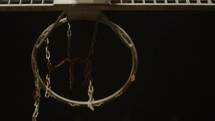 A basketball flies in the air and hits the backboard without going in the hoop