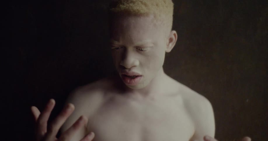 A man looks at his hands in surprise