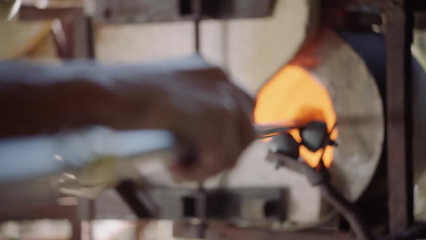 A man heats up metal