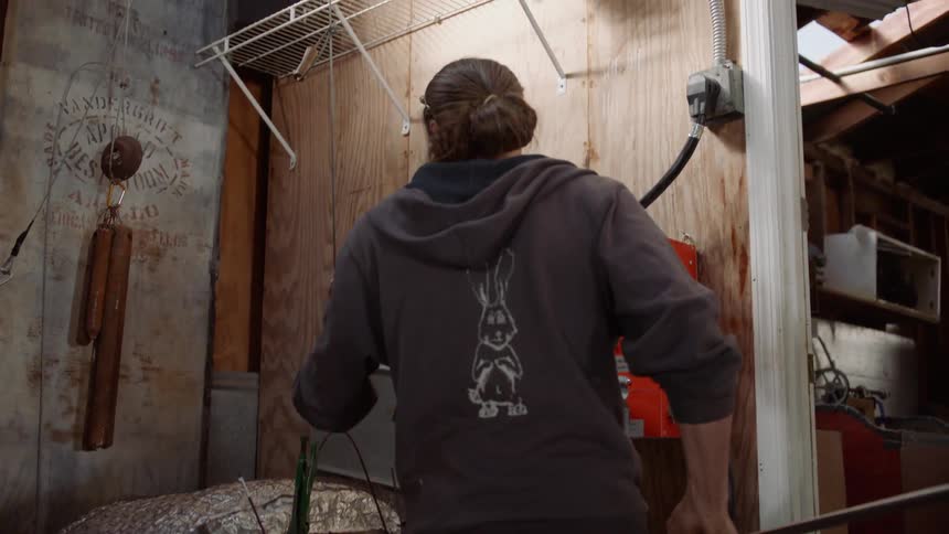 A man closes the lid to a workshop oven