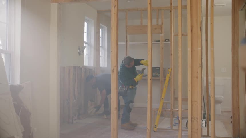 Construction workers building the inside of a house