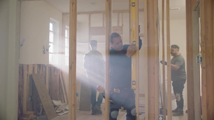 Construction workers build walls together