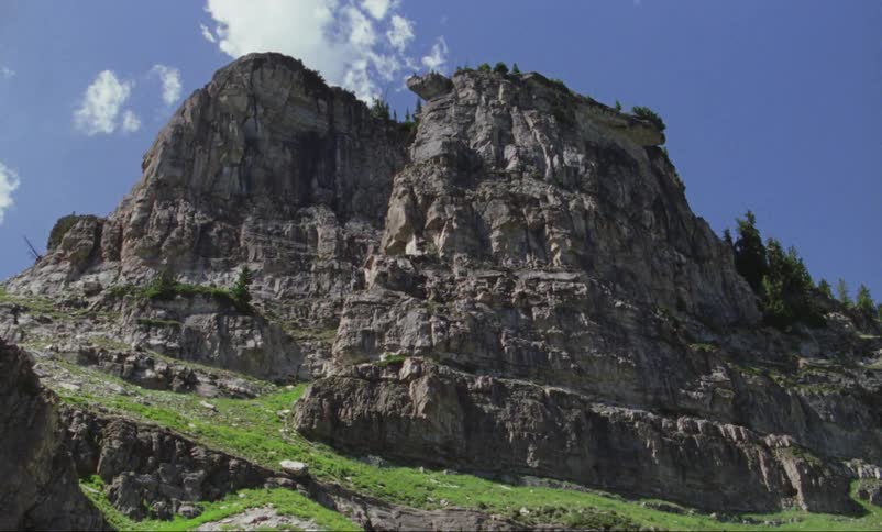 Rocky cliffs stand on a mountainside in the wilderness