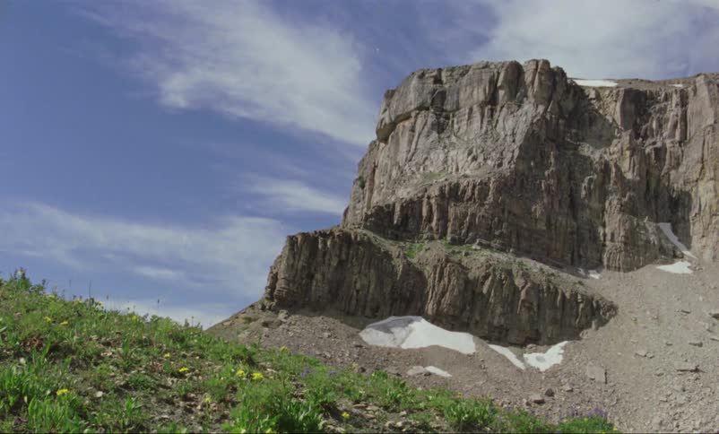 Mountains sit under a blue sky