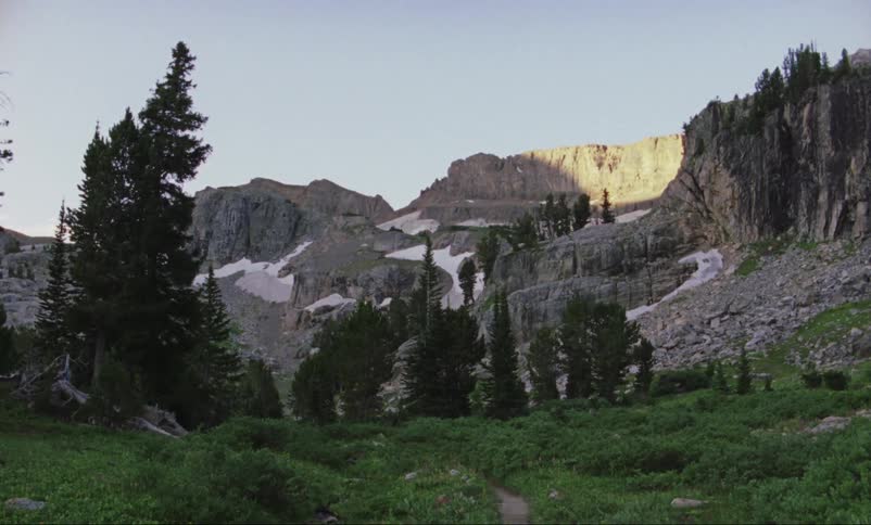 The sun sets on a mountain range