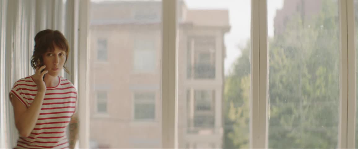 A woman paces while talking on a cell phone