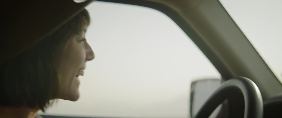 Woman laughing having a good time while driving