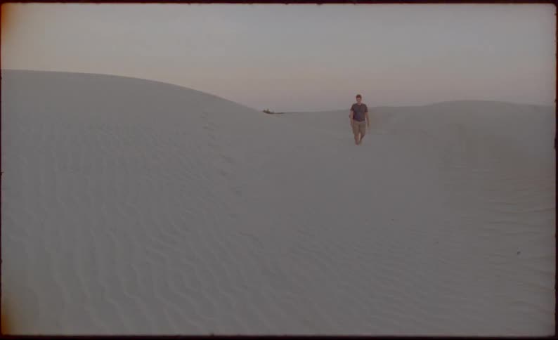 A man is walking in the desert