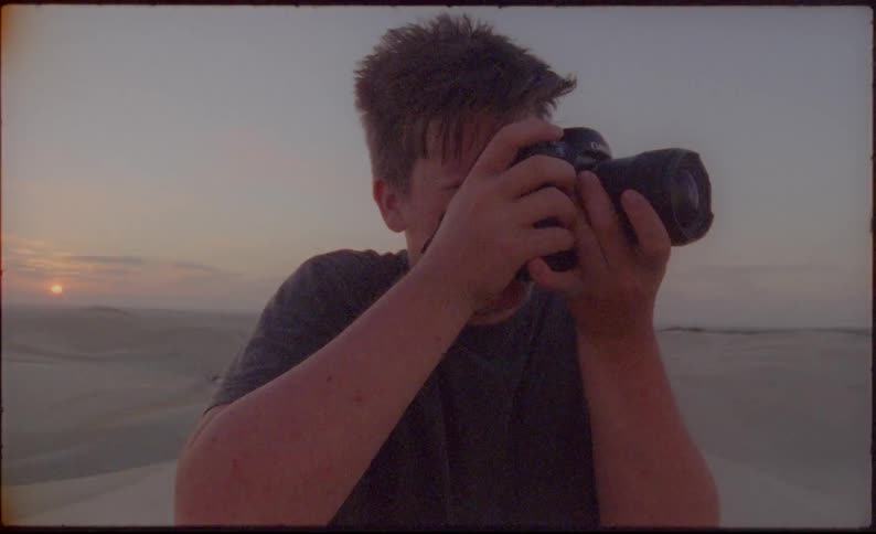 A man is taking a photograph with a camera