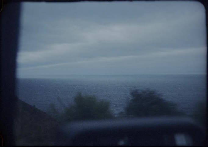 A car drives along side the water