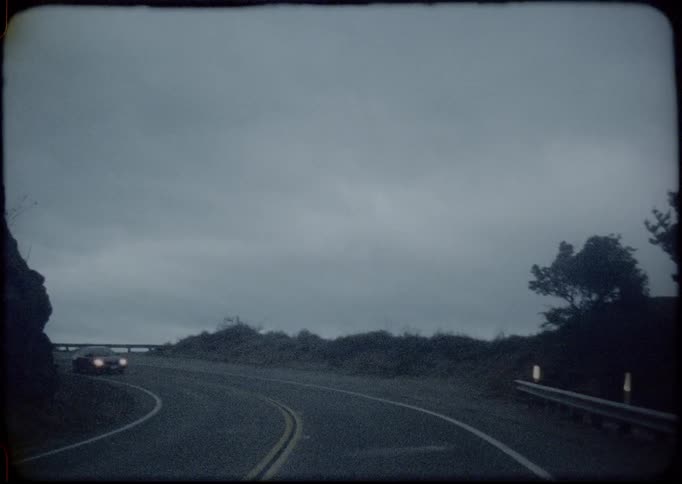 A curving mountain road on a cloudy day
