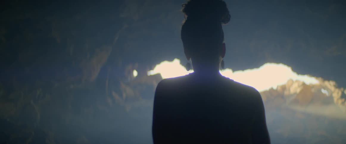 A woman takes pictures in a cave