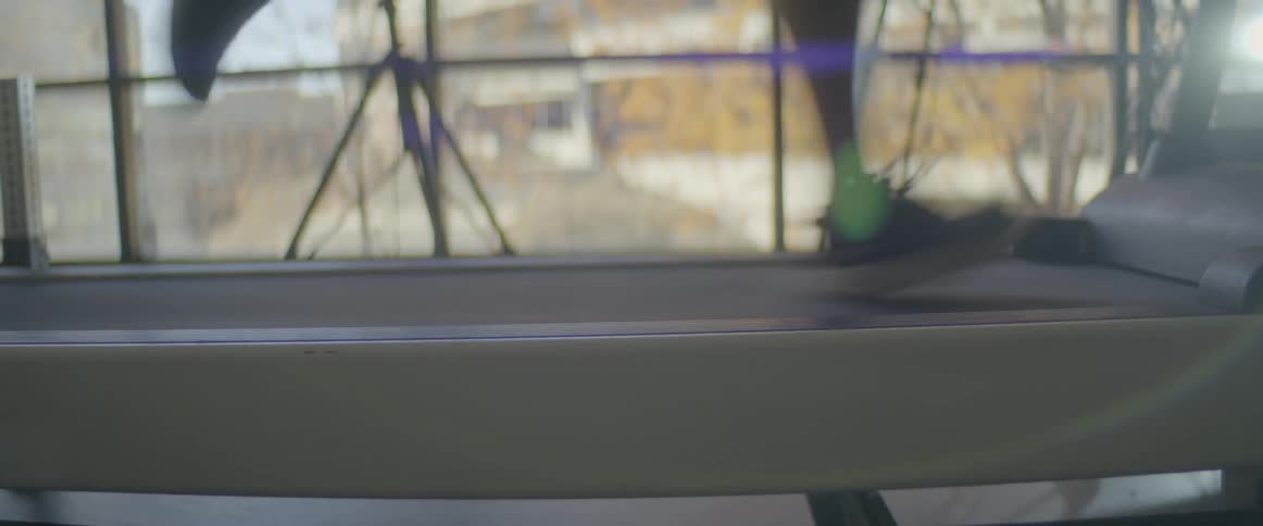 Feet of someone running on a treadmill
