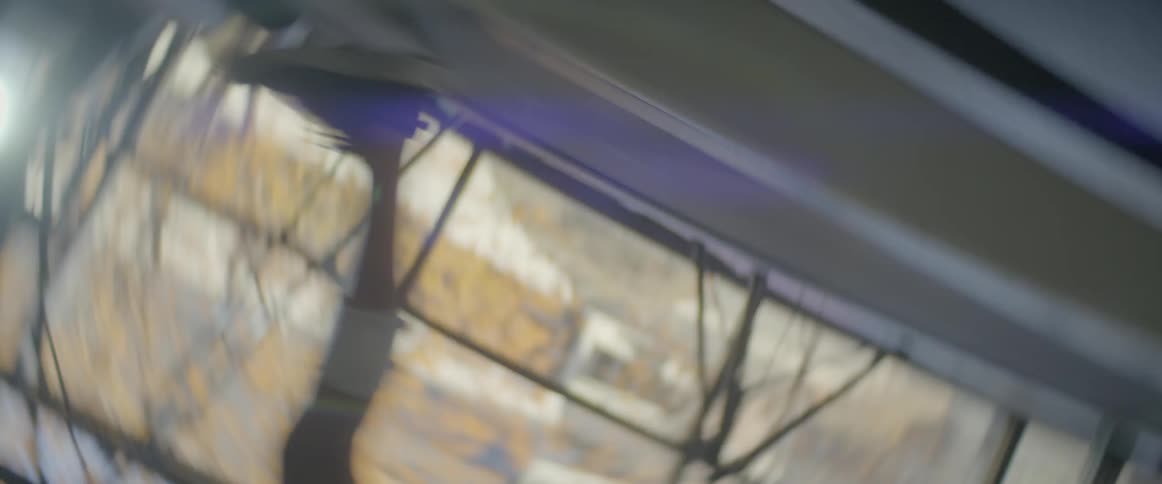 Man runs on a treadmill near a window