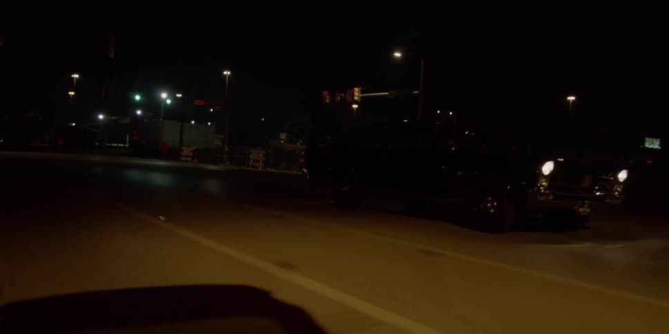Headlights on a car taking an exit shine and glare at night