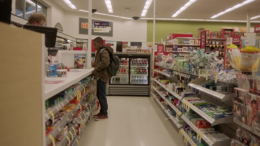 Black boy purchases groceries in the supermarket