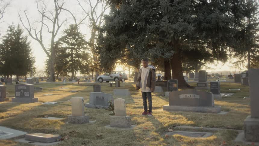 A child stands at the grave