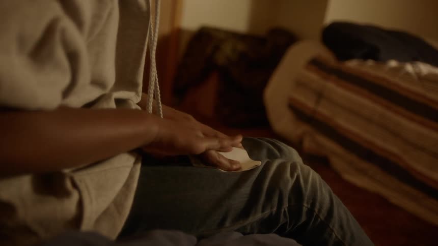 A child folds a piece of paper into a smaller square