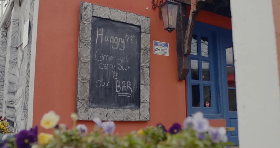 A building with a blackboard sign on the wall